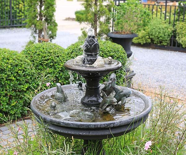 Beautiful Fountain in the park garden. Water flows from the fountain.