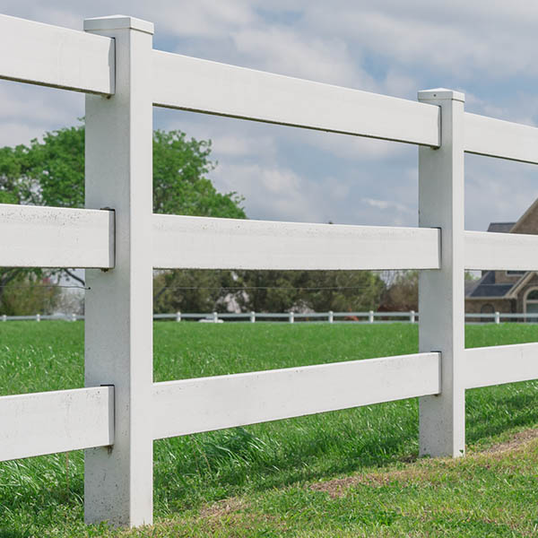 Panorama view wooden white fencing with green grass leads to horizontal line under cloud blue sky in countryside, America. Large farmland and ranch protection background CARSON CITY, NV.