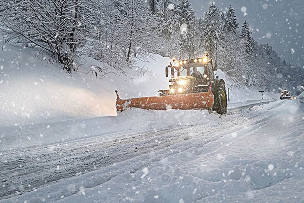 Snow Plow Plowing the Highway During Snow Storm