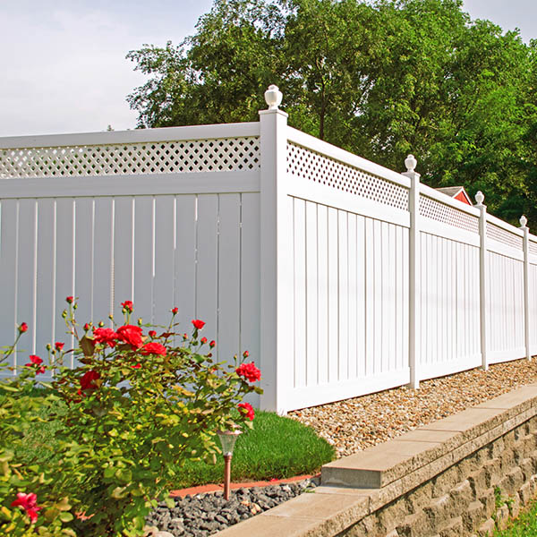Beautiful white vinyl fencing in back yard with nice landscaping in the foreground and background CARSON CITY, NV.