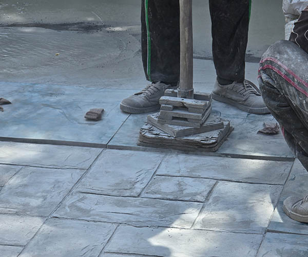Pattaya, Thailand, skilled artisans are busy working on a stunning stamped concrete surface. The intricate patterns and textures come to life under their expert hands.